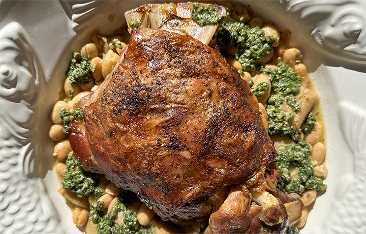 Slow cooked lamb shoulder on butter bean stew, with pickled chilli salsa verde