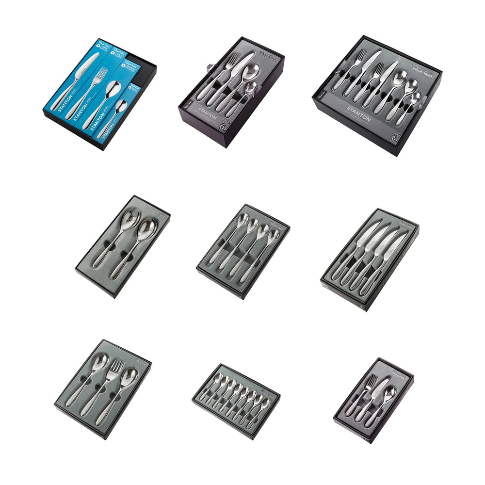 Stainless steel cutlery sets in black boxes on a white background.